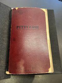 The cover of the travel diary states "Petty Cash," as the book was repurposed from a ledger book.