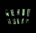 Image of glowing test tubes with lights off
